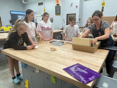 teacher around table with students